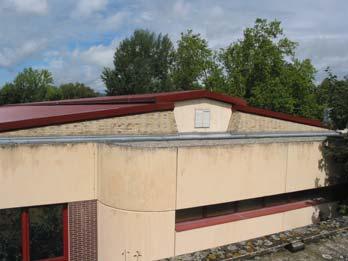 For fire safety, these skylights were removed from the classrooms and the corridor, which were then painted and glazed white, and insulation was added to the exterior