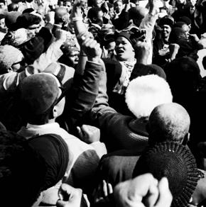 Albertina Sisulu, Linden Johannesburg, 2002. Photograph by Gisele Wulfsohn. Albertina Sisulu leads supporters outside the Palace of Justice in a freedom song at the Rivonia Trial, 1963-1964.